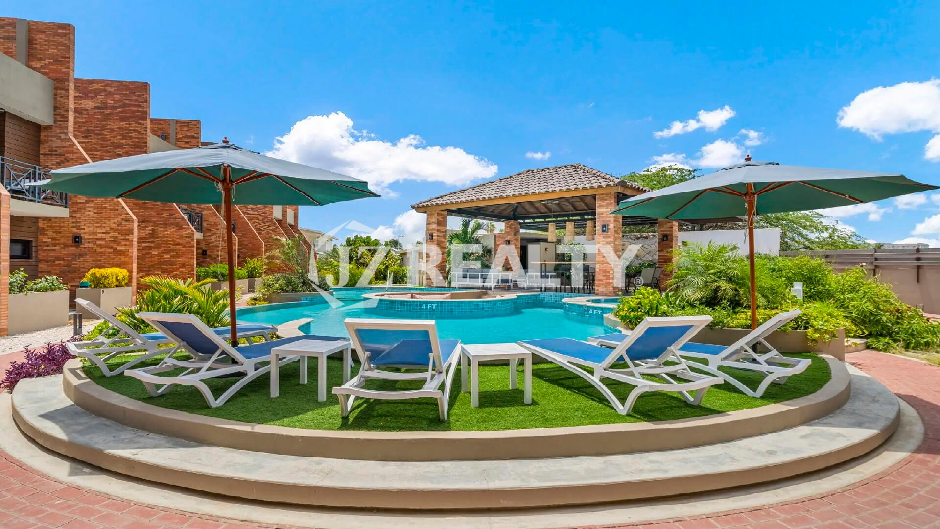 Resort-style community swimming pool at Porta al Sole, featuring sun loungers, umbrellas, and a central gazebo lounge area.