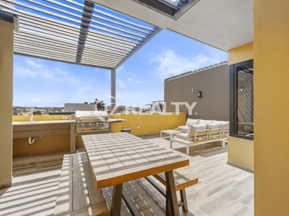 Stunning rooftop terrace at Porta al Sole Unit 12 featuring a slatted pergola, outdoor dining table, built-in BBQ grill area, and comfortable lounge seating, perfect for entertaining.