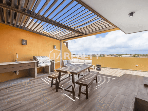 Rooftop deck at Porta al Sole Unit 13 with outdoor grill, sink, covered pergola, wooden dining table, and seating area.