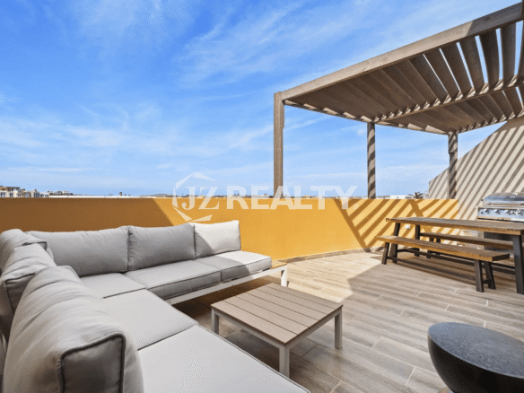 Expansive rooftop terrace with a large sectional sofa, wooden pergola, BBQ grill, and dining bench in Porta al Sole Unit 14.