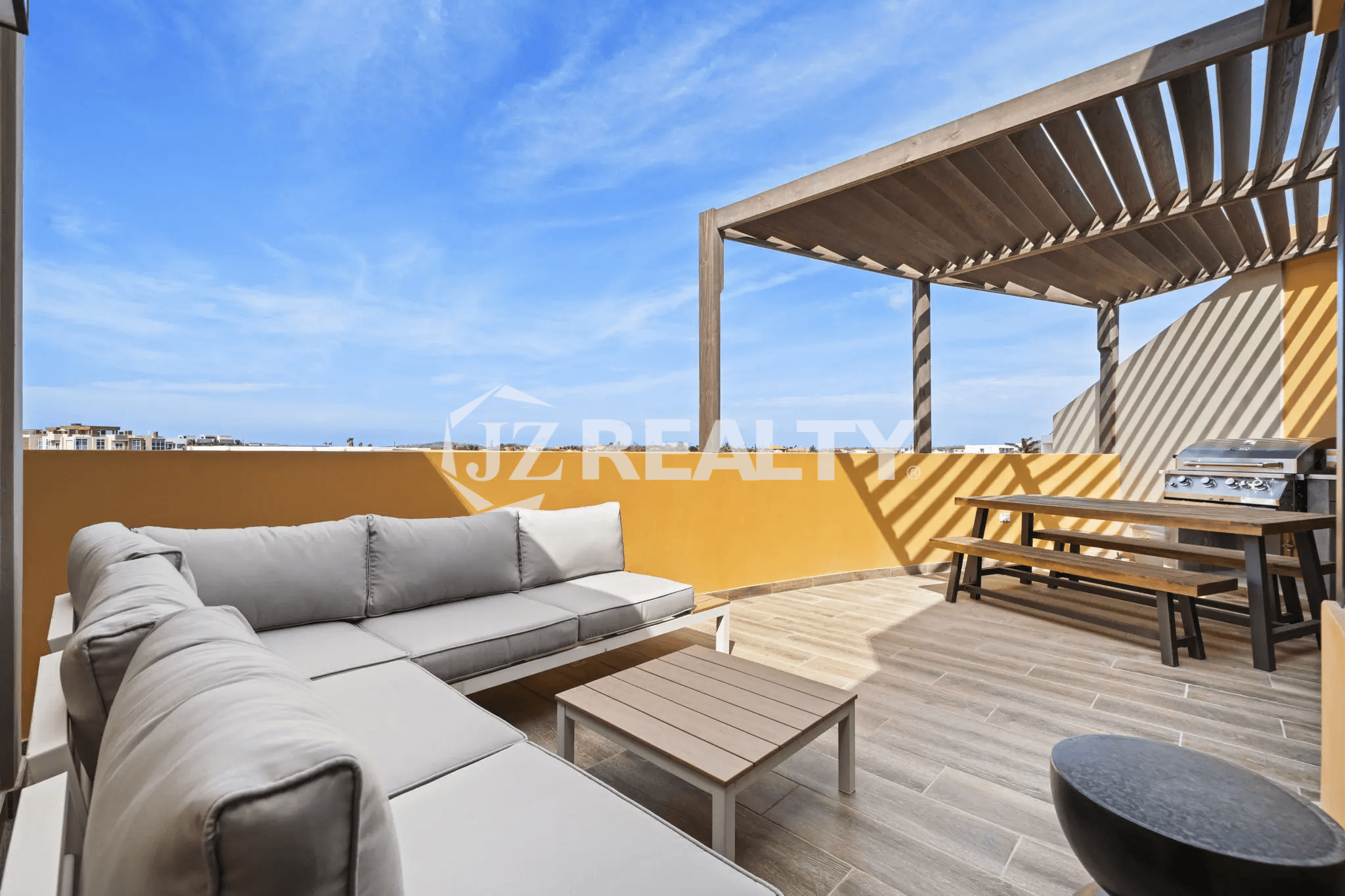Expansive rooftop terrace with a large sectional sofa, wooden pergola, BBQ grill, and dining bench in Porta al Sole Unit 14.