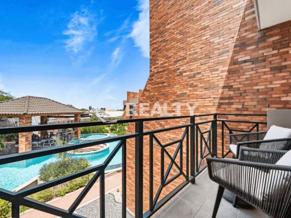 View from a private balcony in Porta al Sole Unit 8 overlooking the community swimming pool and courtyard area.