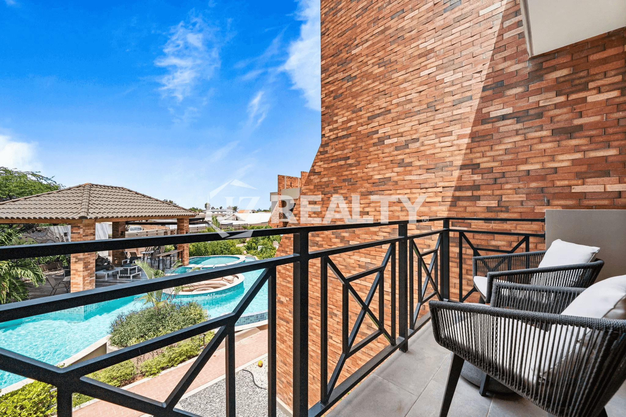 View from a private balcony in Porta al Sole Unit 8 overlooking the community swimming pool and courtyard area.