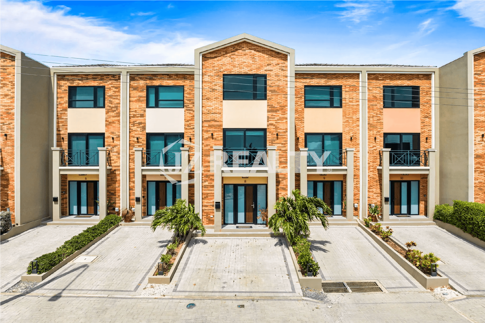 Front view of the Porta al Sole townhouses, showing the brick facade and three-story design of Unit 8.