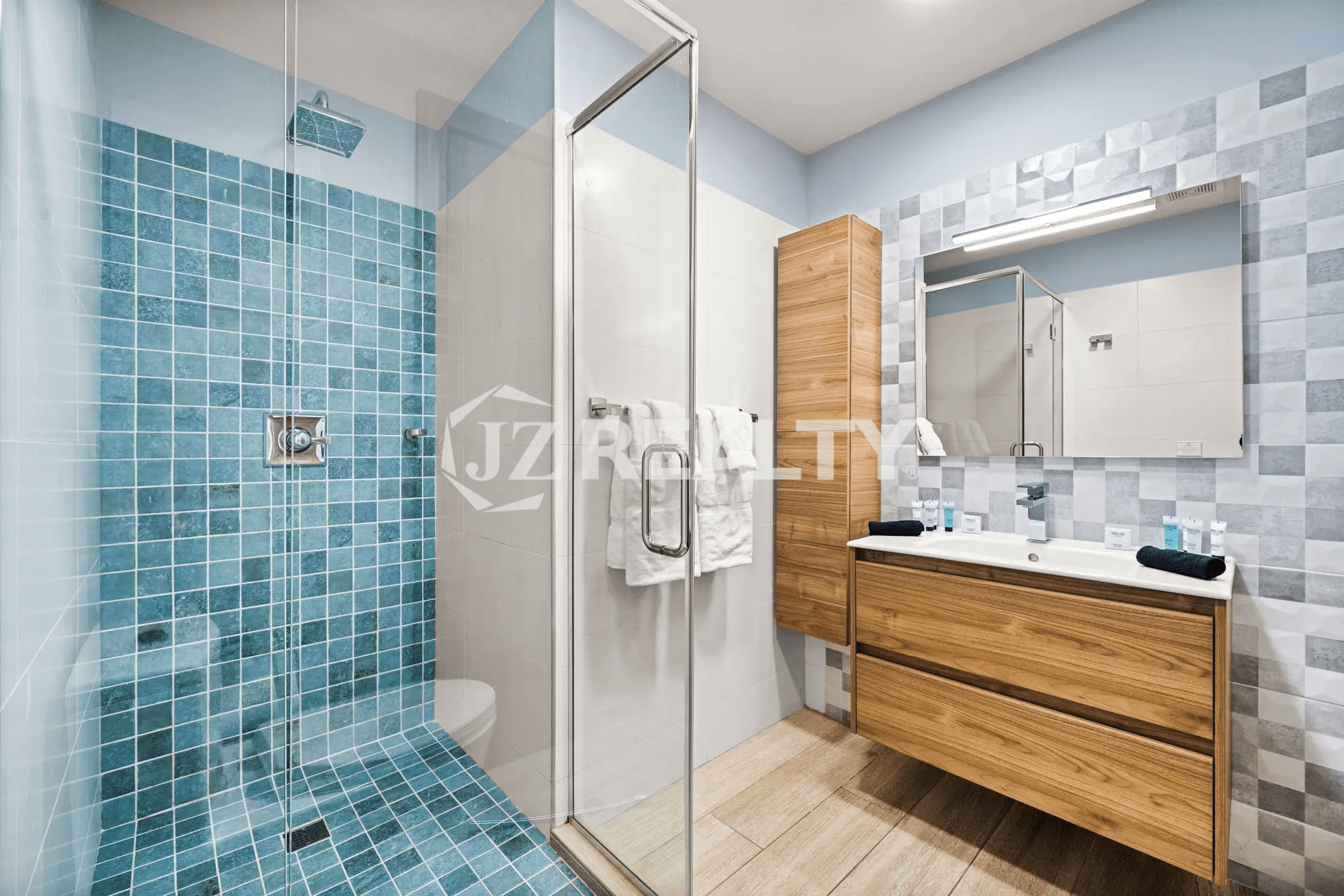 Primary Bathroom in Porta al Sole Unit 8 with a large walk-in shower and a floating wooden vanity with drawers.