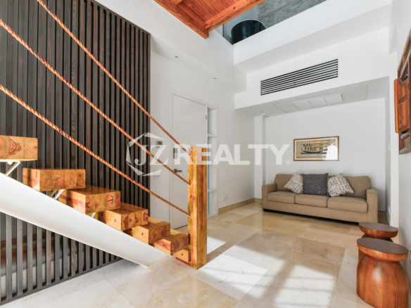 Coral Shell Condo 1E & 2E luxury loft modern entrance with a wooden staircase and stylish decor.