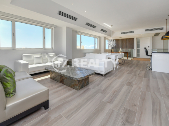 Luxurious dining area in Coral Shell Condo 2E with breathtaking ocean views, modern lighting, and minimalist decor.