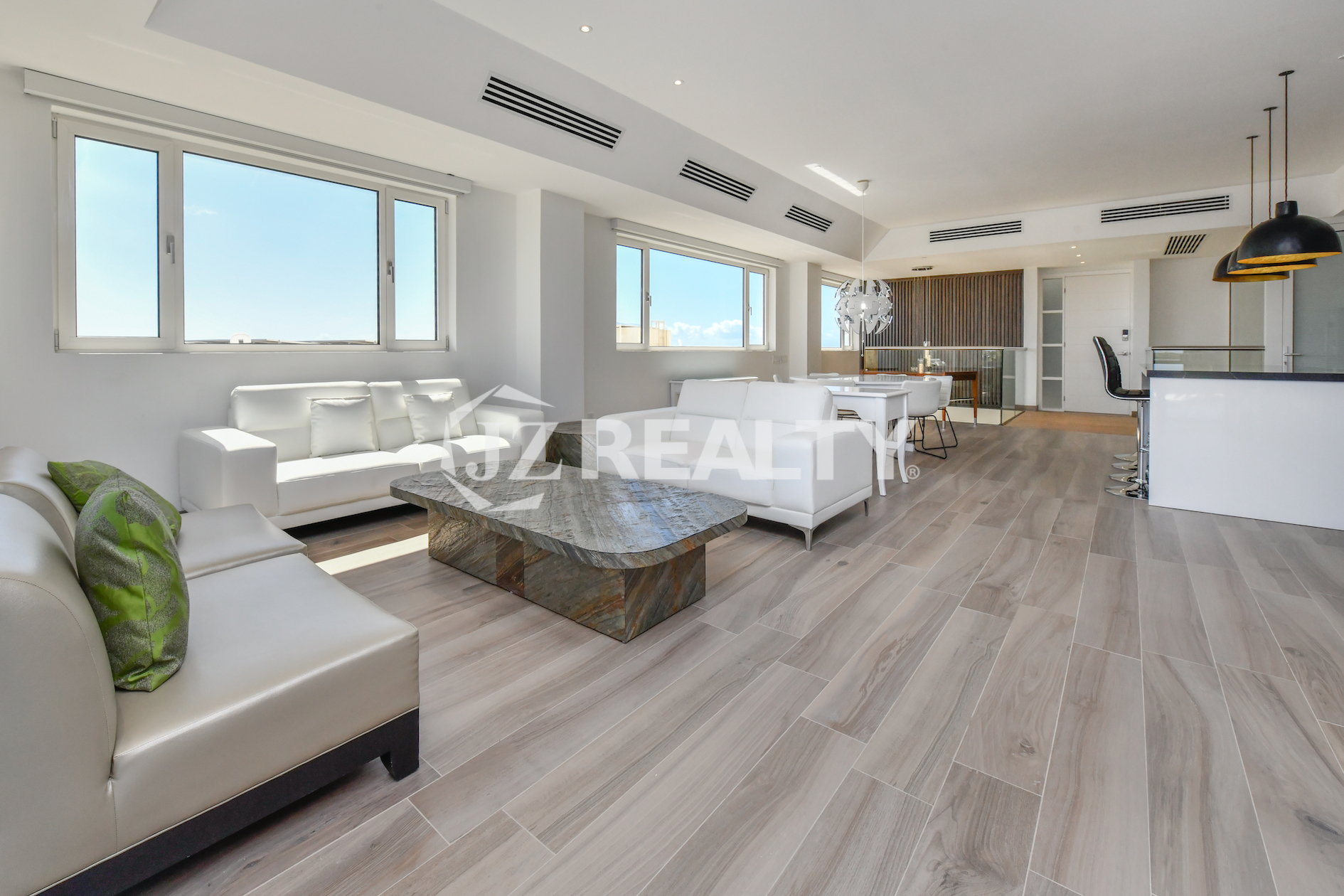 Luxurious dining area in Coral Shell Condo 2E with breathtaking ocean views, modern lighting, and minimalist decor.