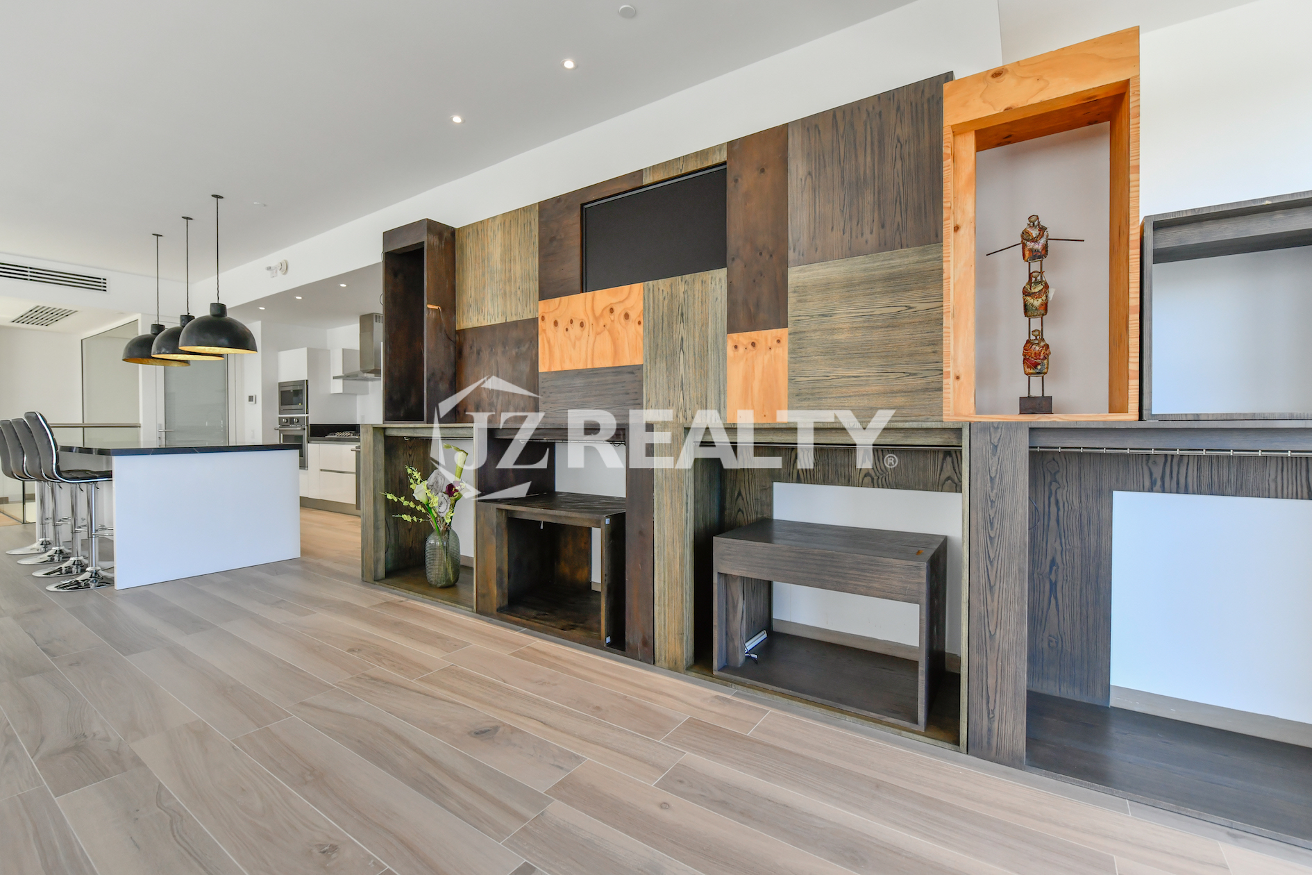Sleek, open-concept kitchen and bar area in Coral Shell Condo 2E, featuring high-end appliances and a marble countertop.