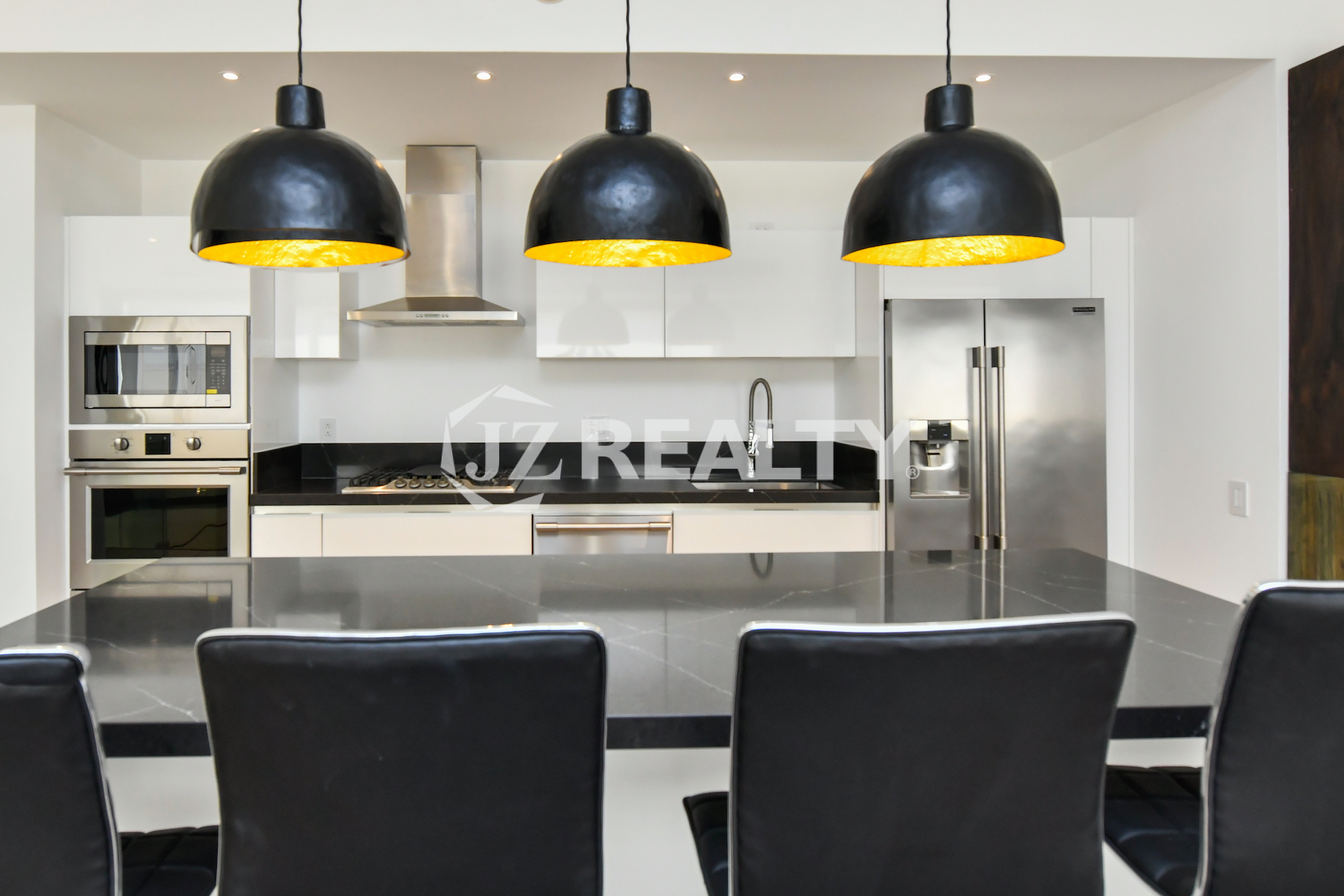Spacious open-concept living area and kitchen in Coral Shell Condo 2E, featuring high ceilings, marble floors, and Italian kitchen furnishings.