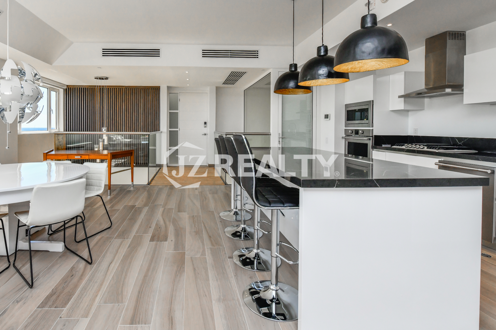 Chic lounge in Coral Shell Condo 1E, featuring a unique custom-built wall design and open living space.