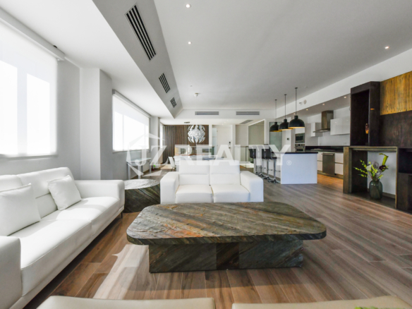 Sleek Italian-designed kitchen in Coral Shell Condo 1E, complete with granite countertops, high-end appliances, and stylish pendant lighting.