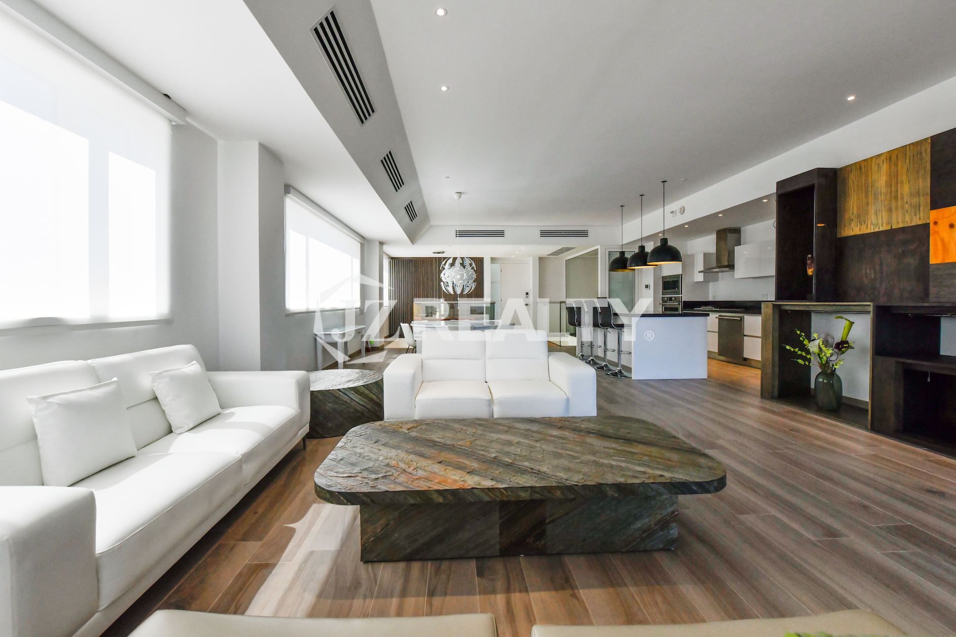 Sleek Italian-designed kitchen in Coral Shell Condo 1E, complete with granite countertops, high-end appliances, and stylish pendant lighting.