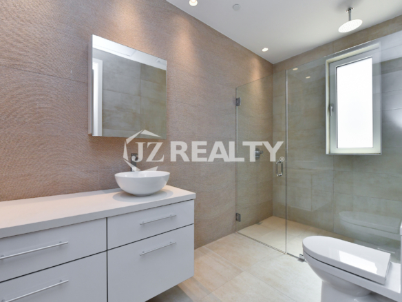 Coral Shell Condo 1E & 2E luxury loft bathroom with floating vanity, vessel sink, and glass shower.