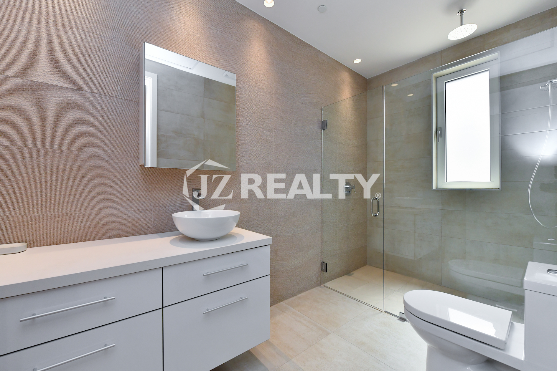 Coral Shell Condo 1E & 2E luxury loft bathroom with floating vanity, vessel sink, and glass shower.