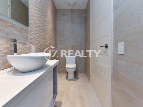 Coral Shell Condo 1E & 2E luxury loft bathroom with 3D textured walls and designer fixtures.
