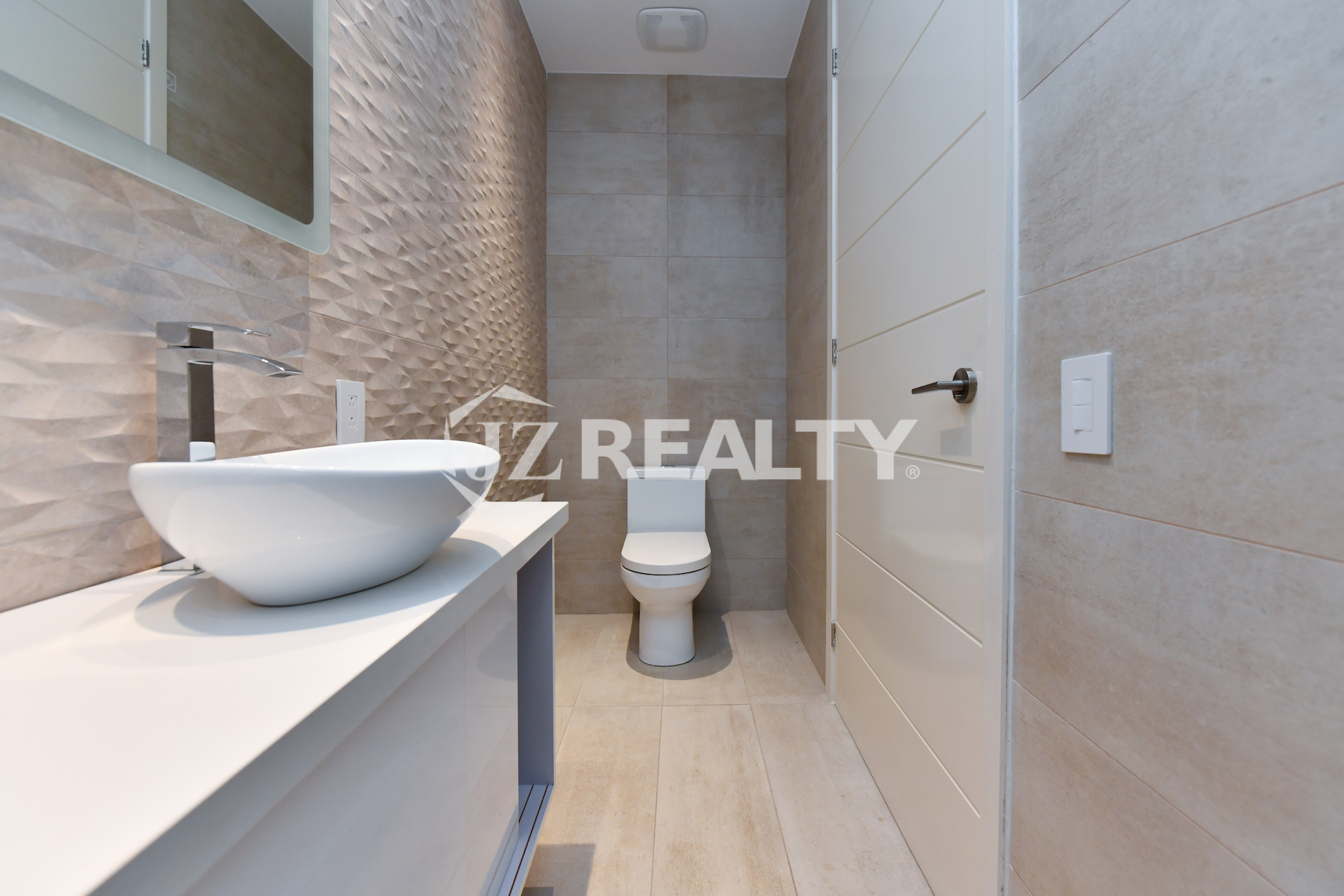 Coral Shell Condo 1E & 2E luxury loft bathroom with 3D textured walls and designer fixtures.