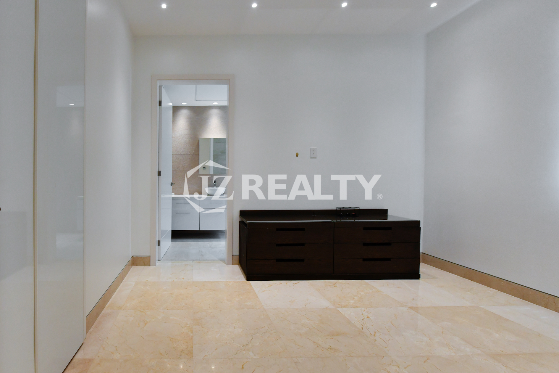 Coral Shell Condo 1E & 2E luxury loft bedroom with glossy marble flooring and minimalist design.