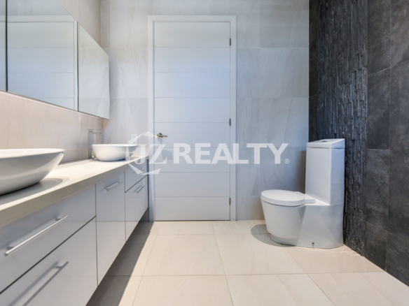 Coral Shell Condo 1E & 2E luxury loft bathroom with a striking contrast of dark and light tiles.