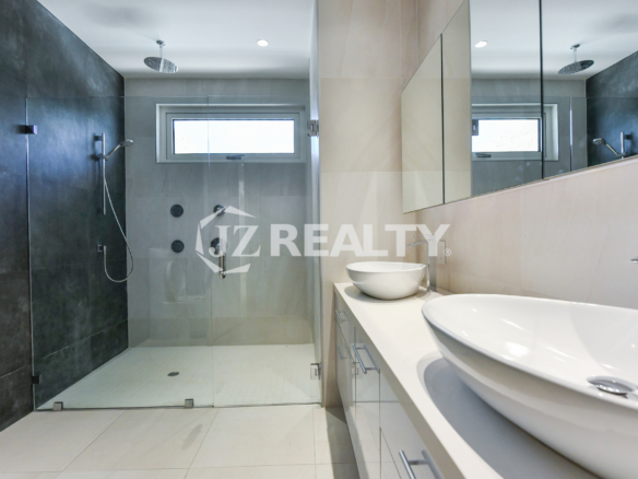 Coral Shell Condo 1E & 2E luxury loft dual sink bathroom with contemporary lighting and sleek fixtures.