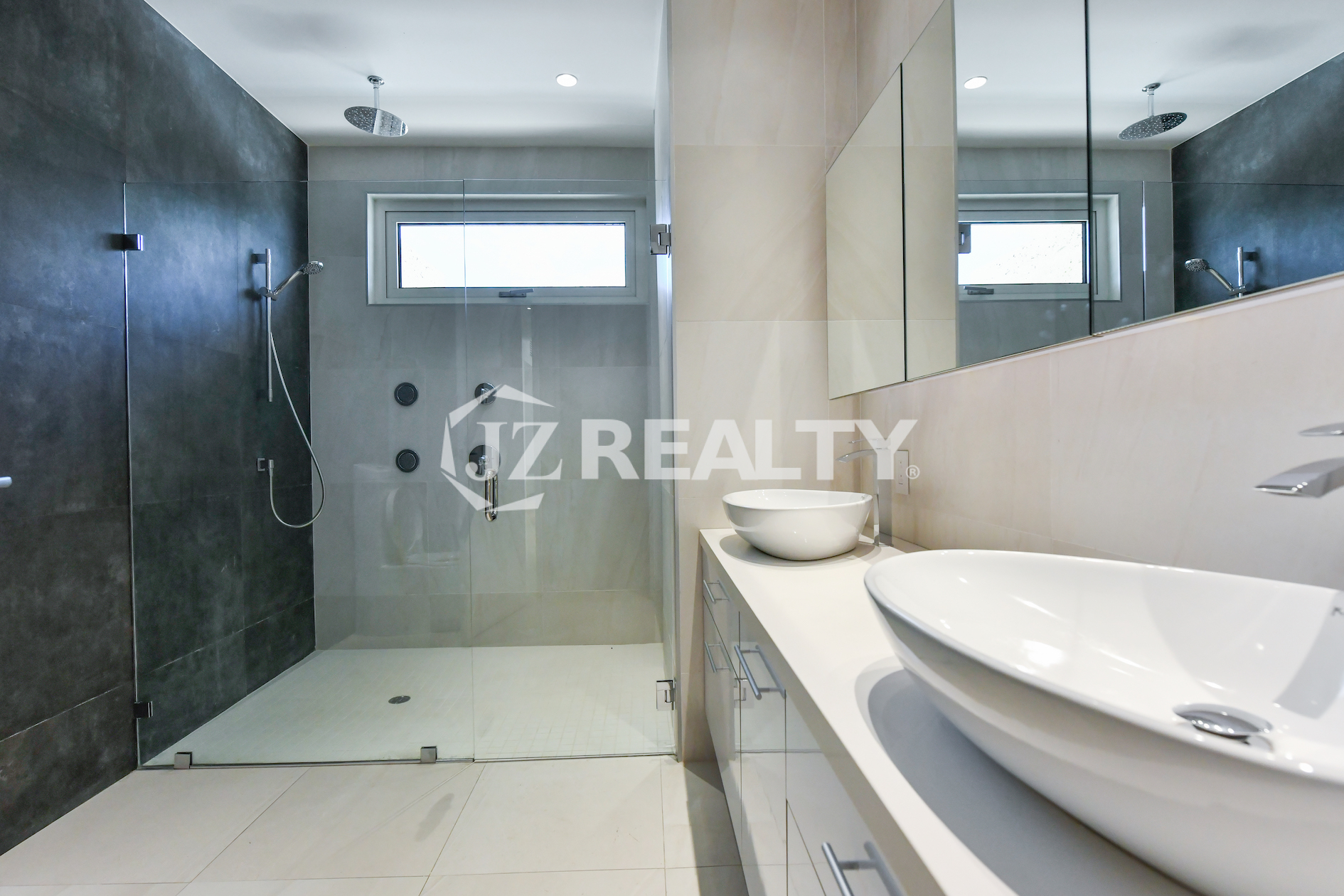 Coral Shell Condo 1E & 2E luxury loft dual sink bathroom with contemporary lighting and sleek fixtures.