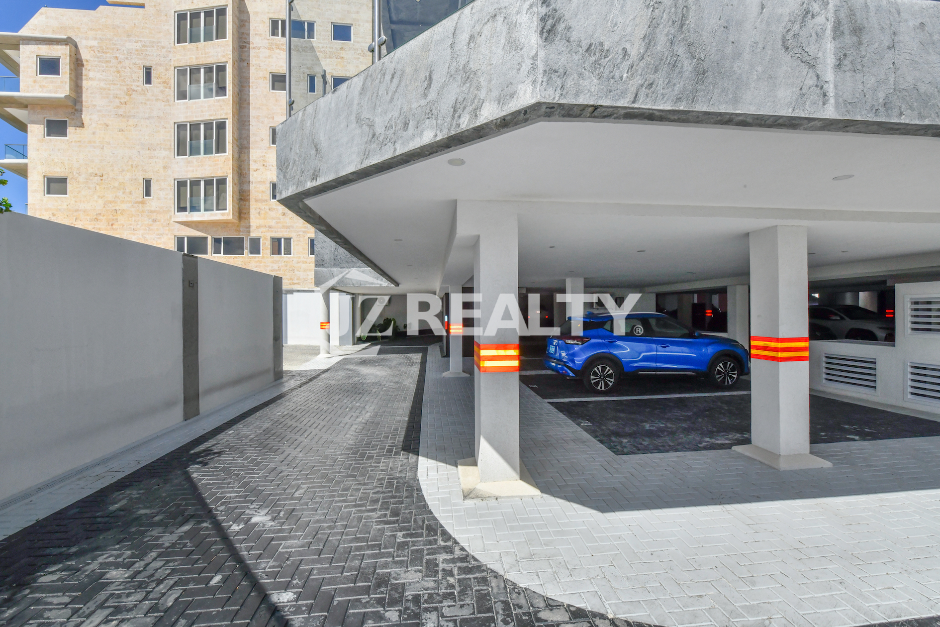 A secure and well-lit covered parking area at Coral Shell Condo in Aruba, ensuring residents and guests have convenient and safe vehicle storage.