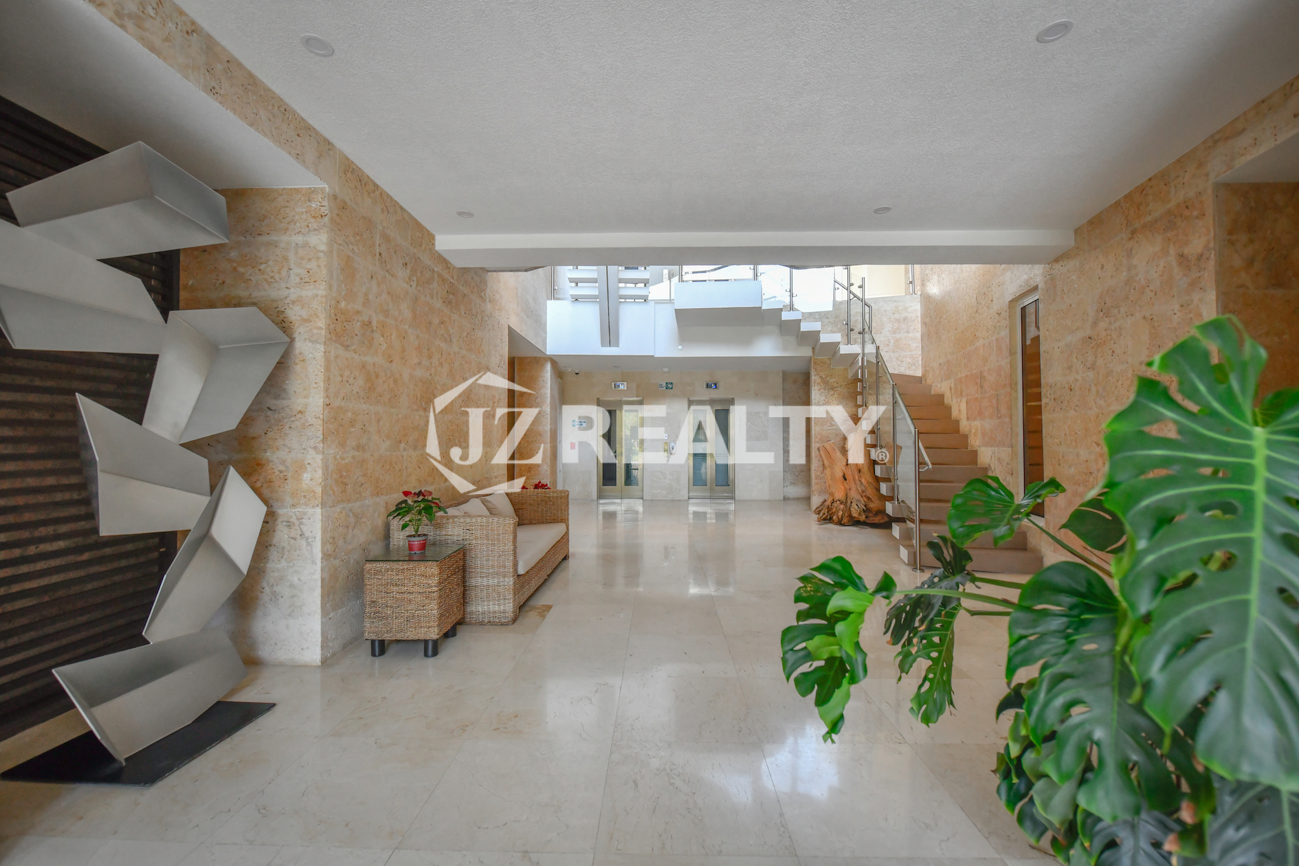 The spacious and elegantly designed lobby at Coral Shell Condo in Aruba welcomes residents with modern architecture and a sophisticated ambiance.