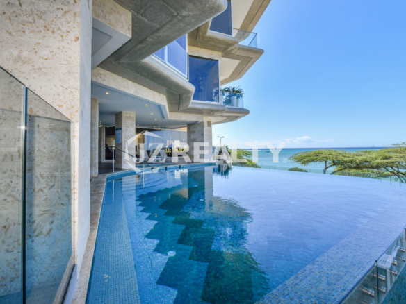 This image showcases the stunning infinity pool at Coral Shell Condo in Aruba, offering breathtaking ocean views and a luxurious waterfront experience for residents.