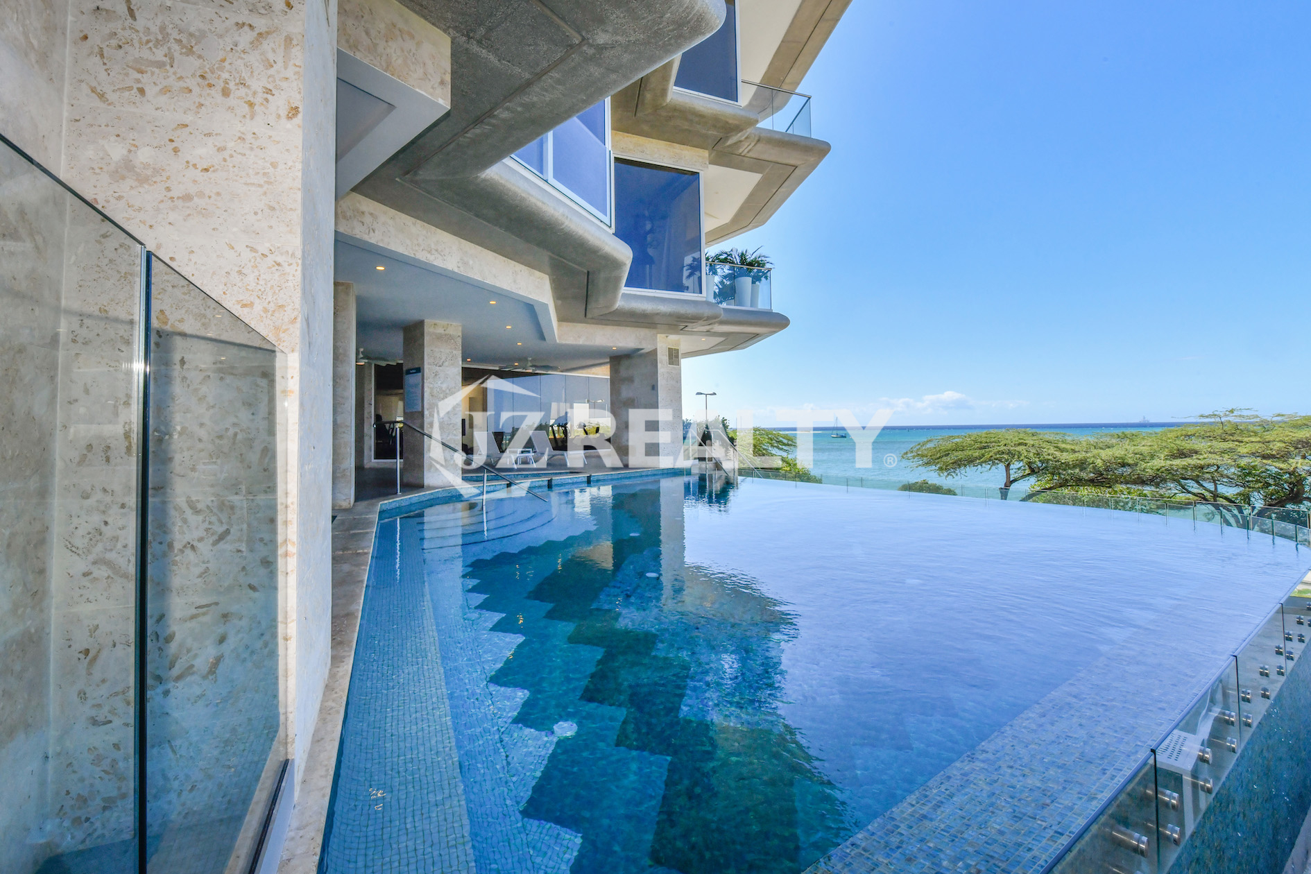 This image showcases the stunning infinity pool at Coral Shell Condo in Aruba, offering breathtaking ocean views and a luxurious waterfront experience for residents.