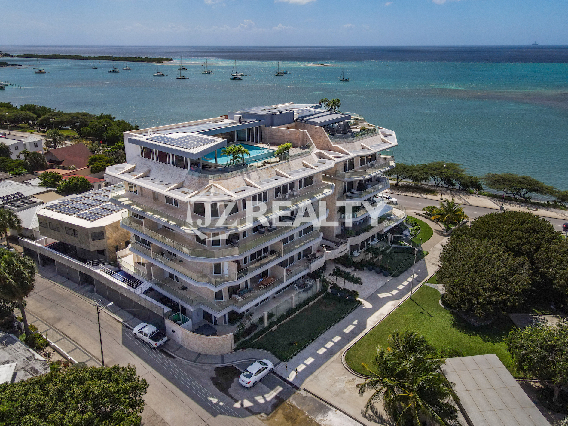 An aerial perspective of Coral Shell Condo in Aruba, highlighting its prime oceanfront location and high-end residential amenities.