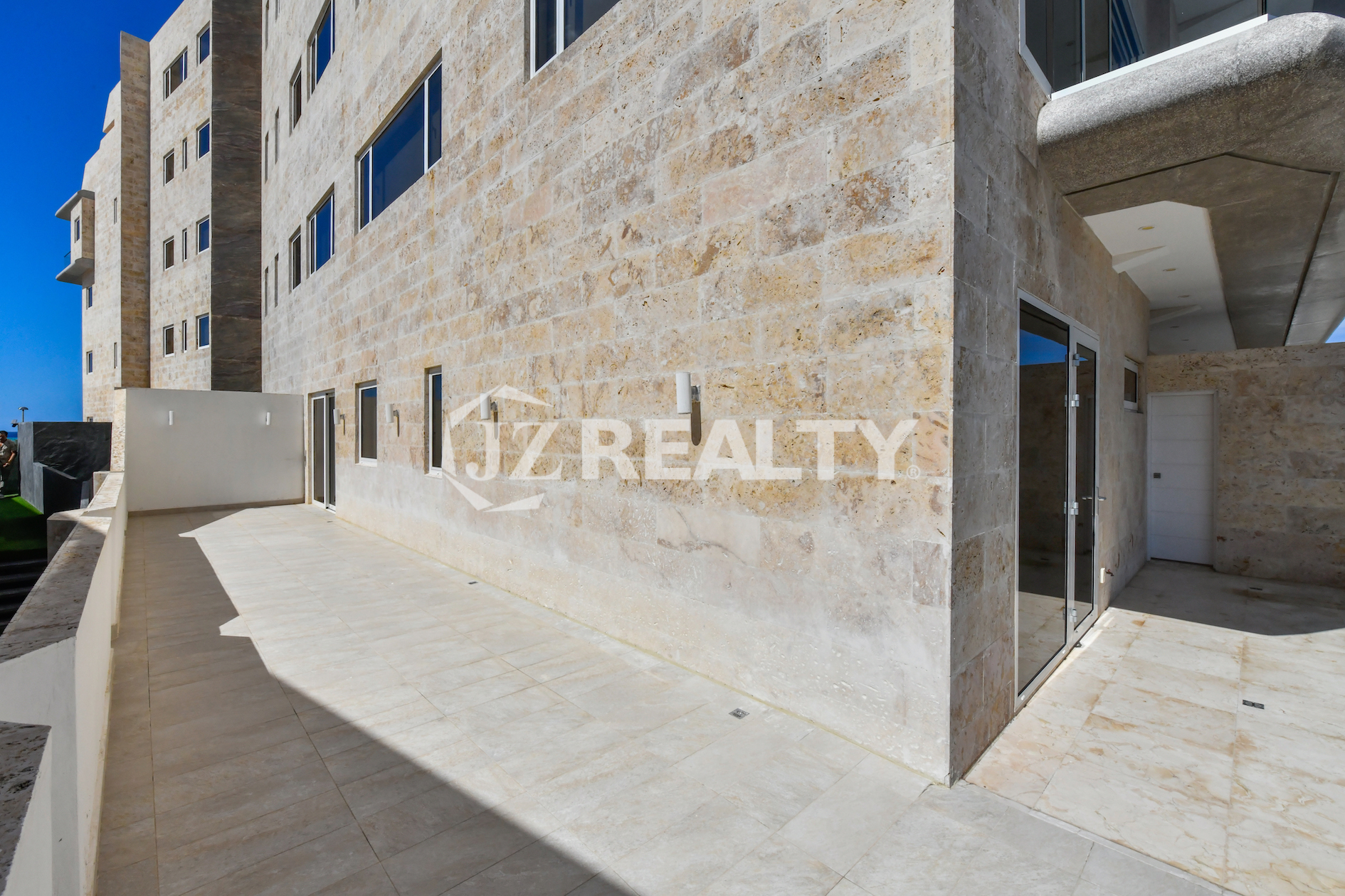 A spacious private terrace at Coral Shell Condo in Aruba, designed for relaxation and entertainment with a seamless indoor-outdoor living experience.