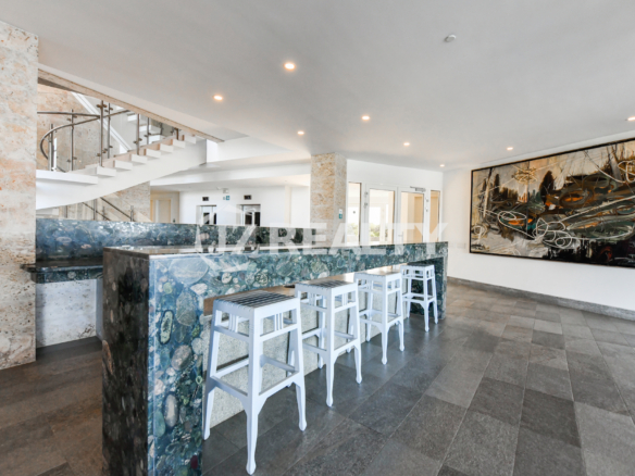 The stylish rooftop lounge and bar area at Coral Shell Condo in Aruba, providing residents with a social space featuring panoramic ocean views.