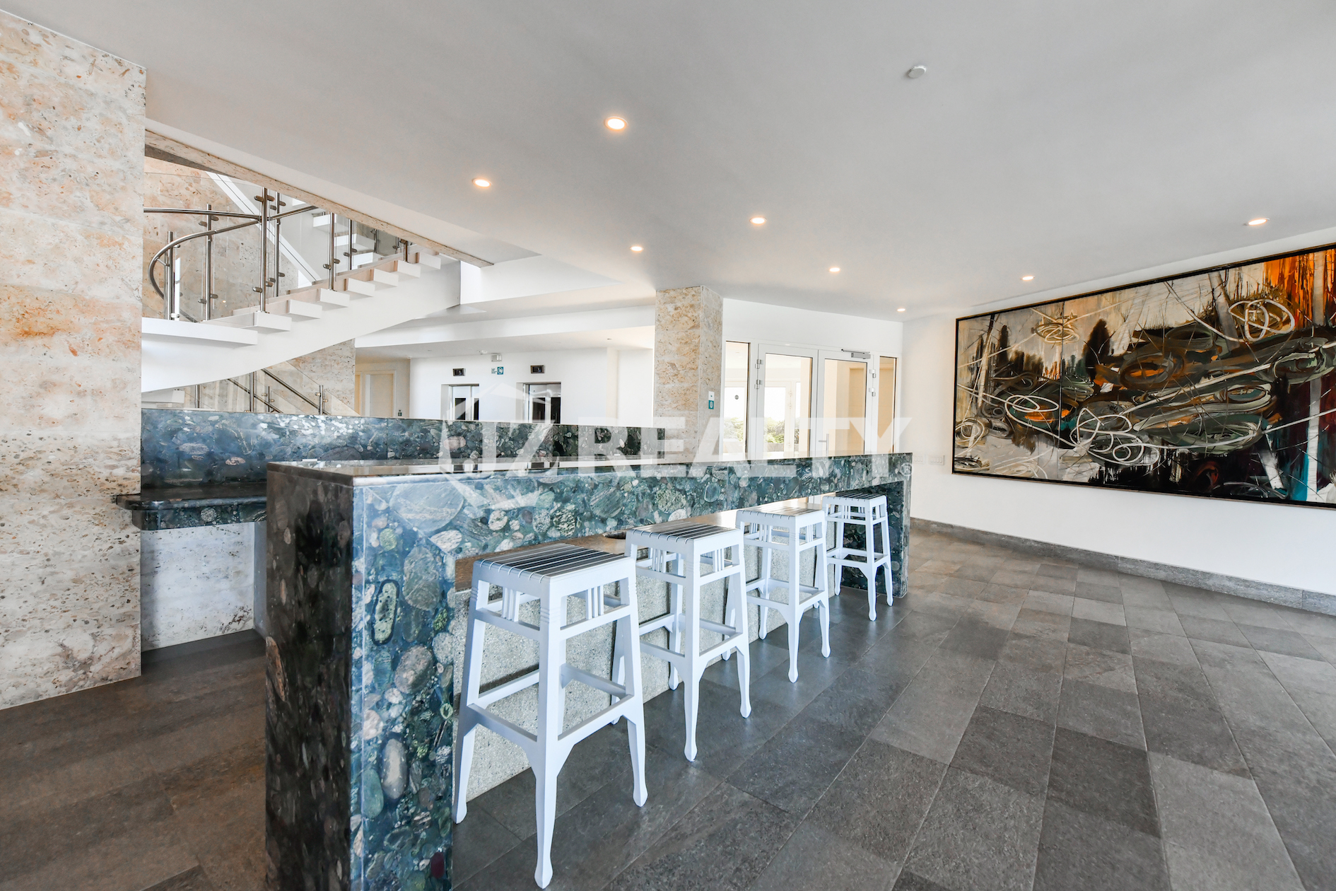 The stylish rooftop lounge and bar area at Coral Shell Condo in Aruba, providing residents with a social space featuring panoramic ocean views.
