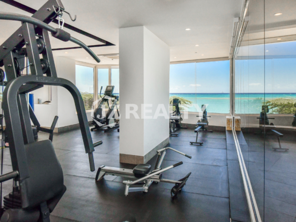 The state-of-the-art gym at Coral Shell Condo in Aruba features panoramic ocean views, creating a perfect setting for residents to enjoy fitness with a tropical backdrop.