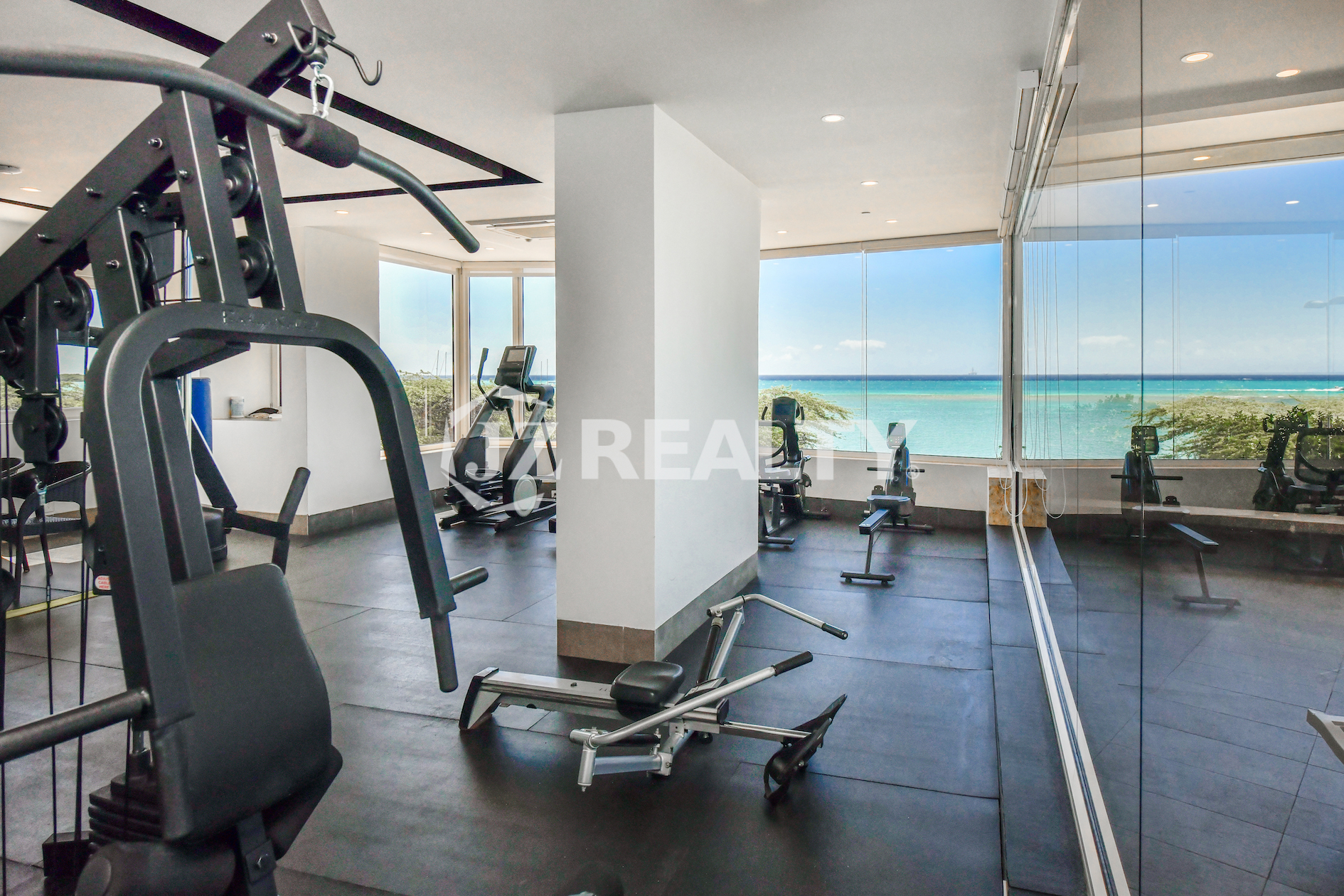 The state-of-the-art gym at Coral Shell Condo in Aruba features panoramic ocean views, creating a perfect setting for residents to enjoy fitness with a tropical backdrop.