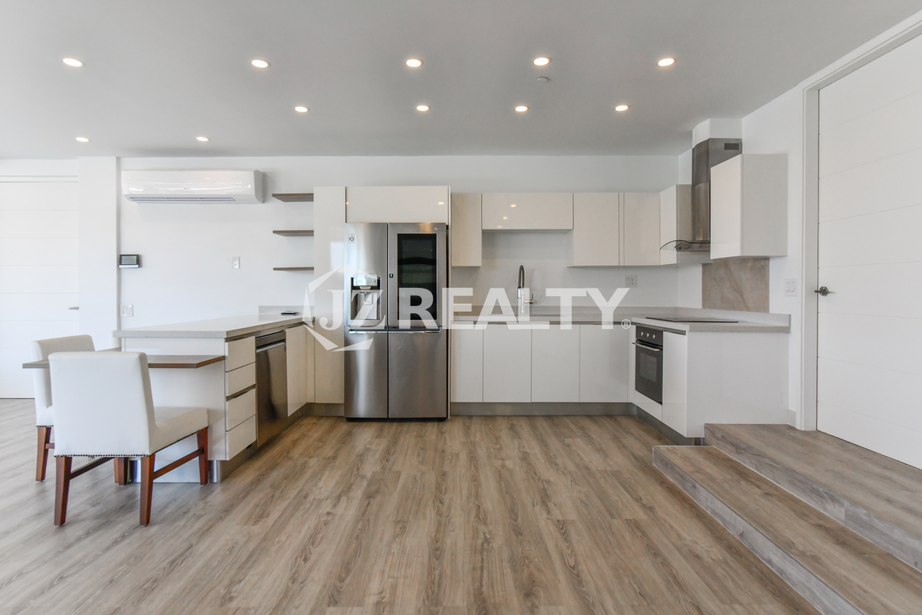 Contemporary open-concept kitchen with stainless steel appliances in Condo 1H, Coral Shell Condominium, Aruba.