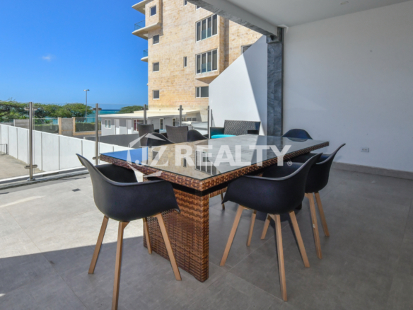 Private outdoor dining area with ocean view at Condo 1H in Coral Shell Condominium, Oranjestad, Aruba.