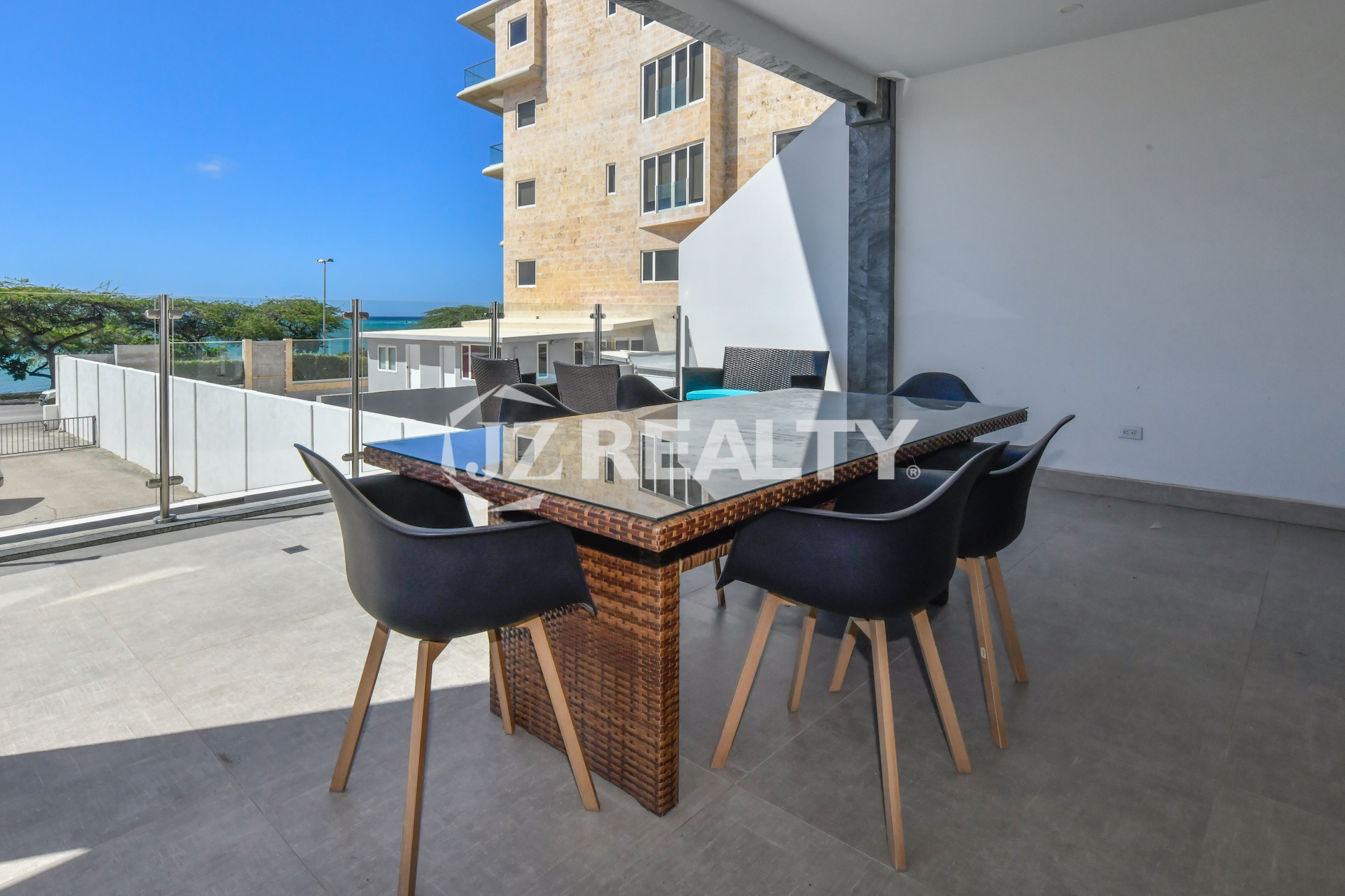 Private outdoor dining area with ocean view at Condo 1H in Coral Shell Condominium, Oranjestad, Aruba.