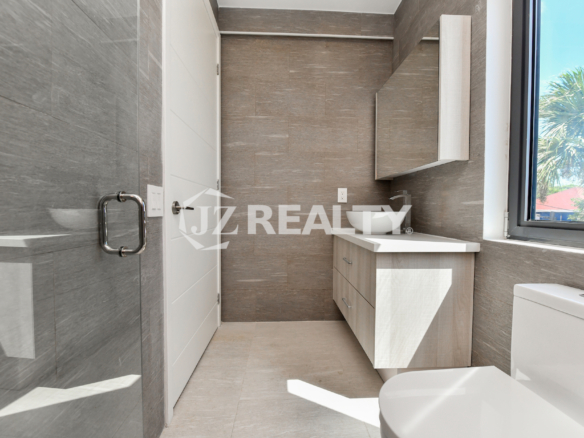 Elegant bathroom with modern finishes in Coral Shell Condo 1H, Aruba.