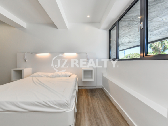 Cozy bedroom with stylish decor in Coral Shell Condo 1H, Oranjestad, Aruba.