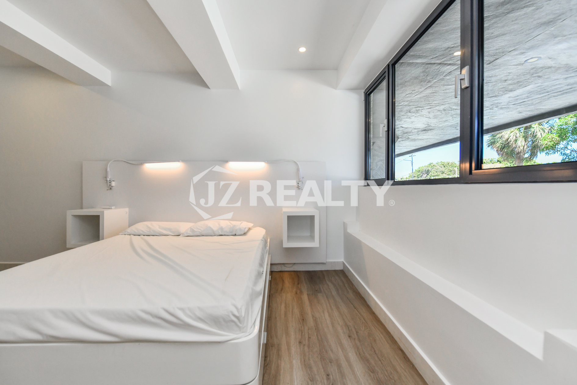 Cozy bedroom with stylish decor in Coral Shell Condo 1H, Oranjestad, Aruba.