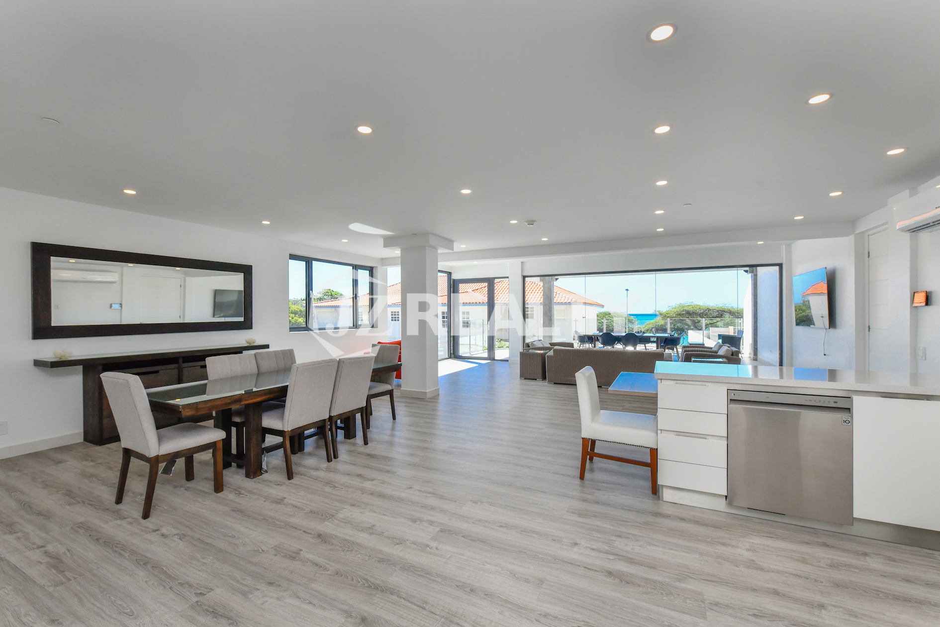 Open-plan living area with ocean views at Coral Shell Condo 1H in Oranjestad, Aruba.