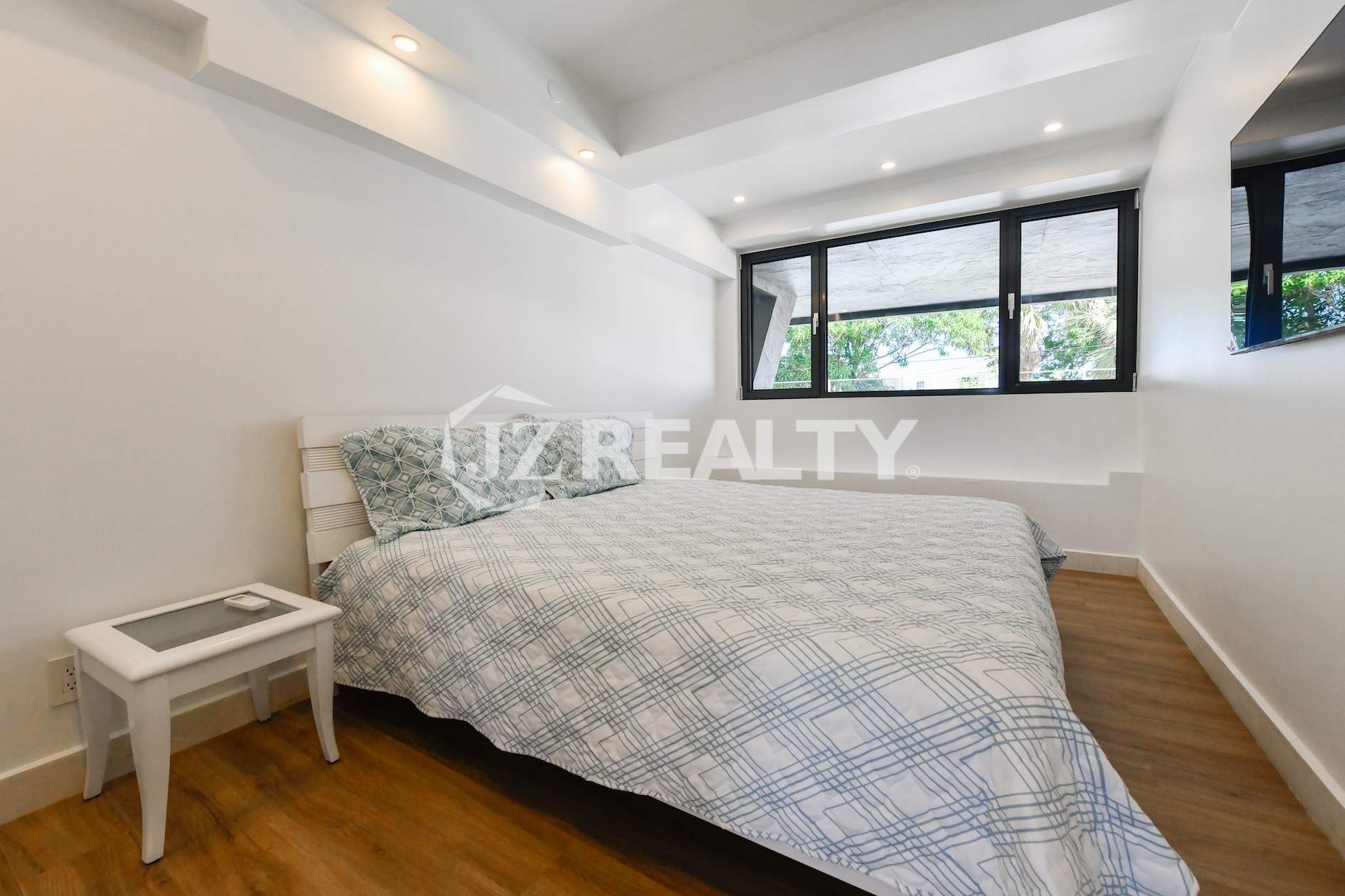 Spacious master bedroom with modern furnishings in Coral Shell Condo 1H, Oranjestad, Aruba.