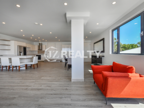 Open-layout living space with modern furnishings in Coral Shell Condo 1H, Aruba.