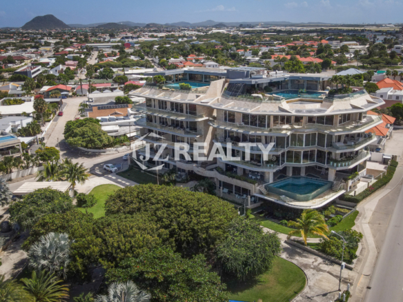 A stunning aerial view of Coral Shell Condo in Aruba, overlooking the turquoise waters of the Caribbean.
