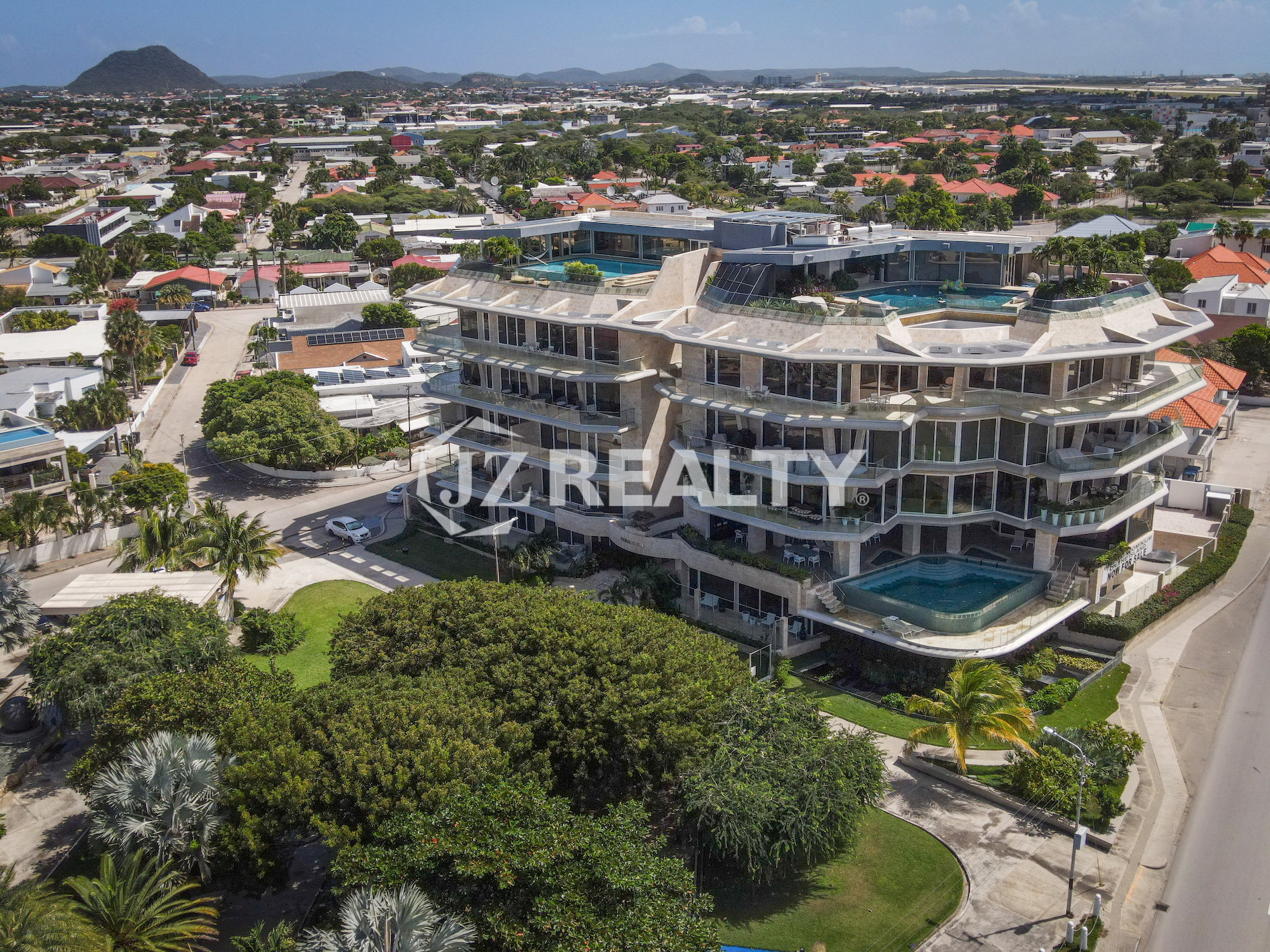 A stunning aerial view of Coral Shell Condo in Aruba, overlooking the turquoise waters of the Caribbean.