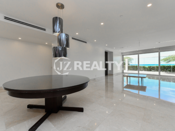 Elegant dining area with designer lighting and polished marble floors at Coral Shell Condo GF-C, Oranjestad, Aruba.