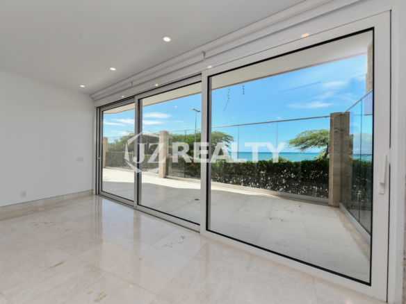 Modern master bedroom with private patio access at Coral Shell Condo GF-C in Oranjestad, Aruba.