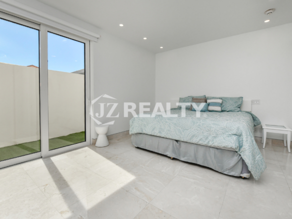 Spacious oceanfront living room with modern finishes and breathtaking sea views at Coral Shell Condo GF-C, Oranjestad, Aruba.