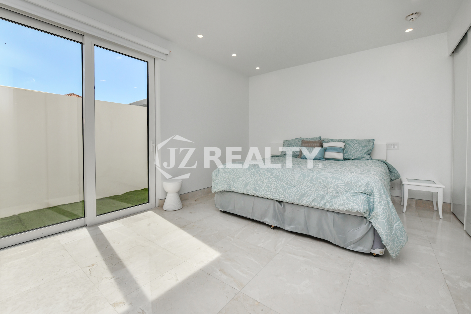 Spacious oceanfront living room with modern finishes and breathtaking sea views at Coral Shell Condo GF-C, Oranjestad, Aruba.